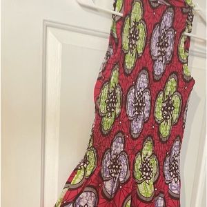 Colorful sleeveless dress some smocking around waist.